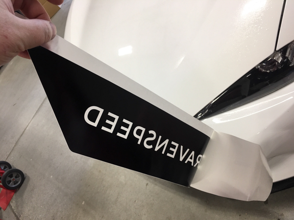 Peeling the backing from the decal