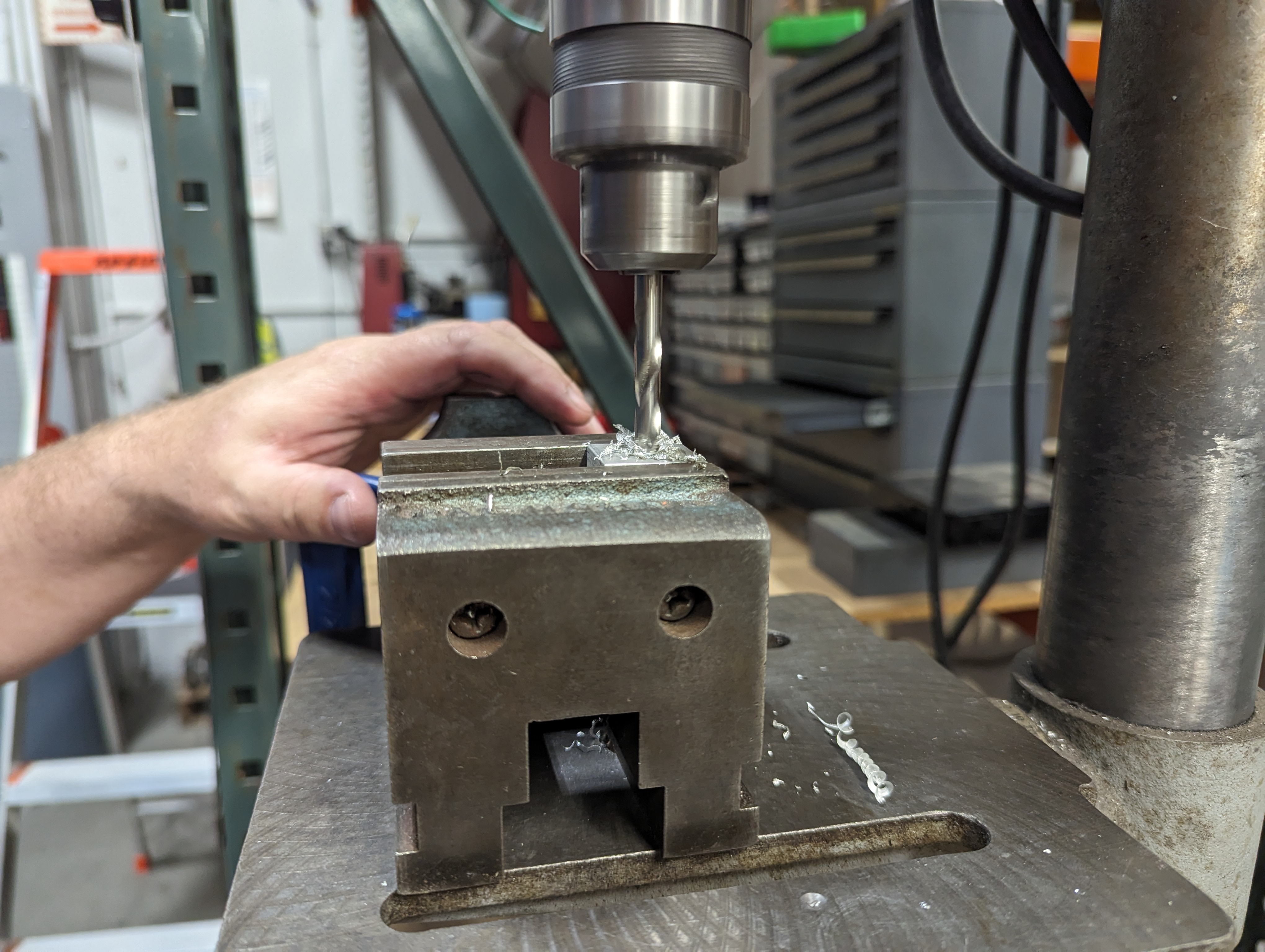 Drilling out the aluminum angle framing brackets on our drill press