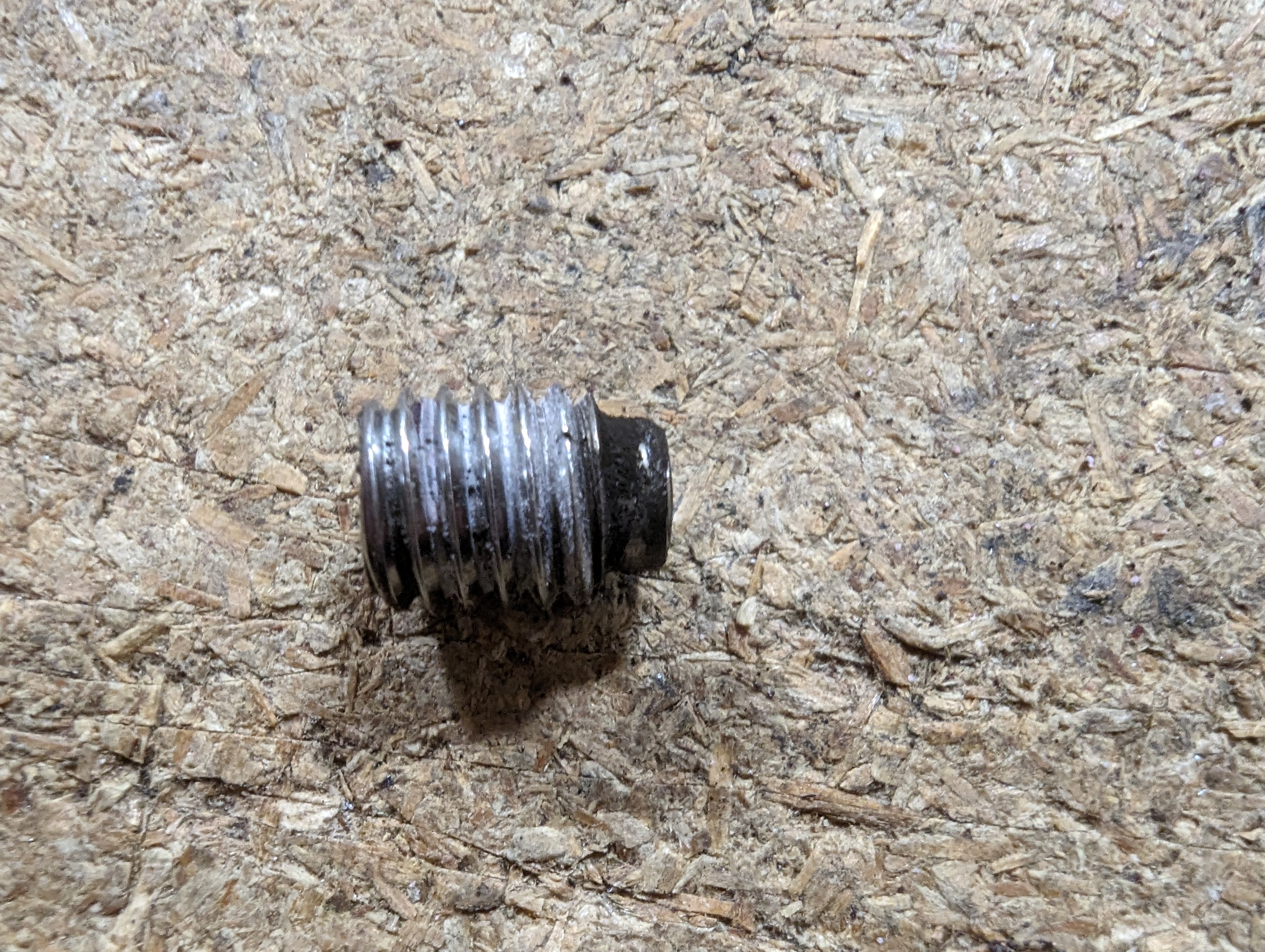 A very worn and damaged grub screw