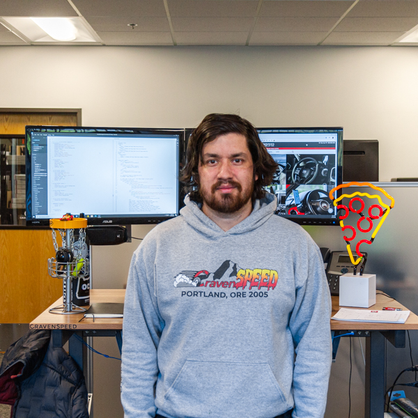 Logan standing in front of his desk in the office