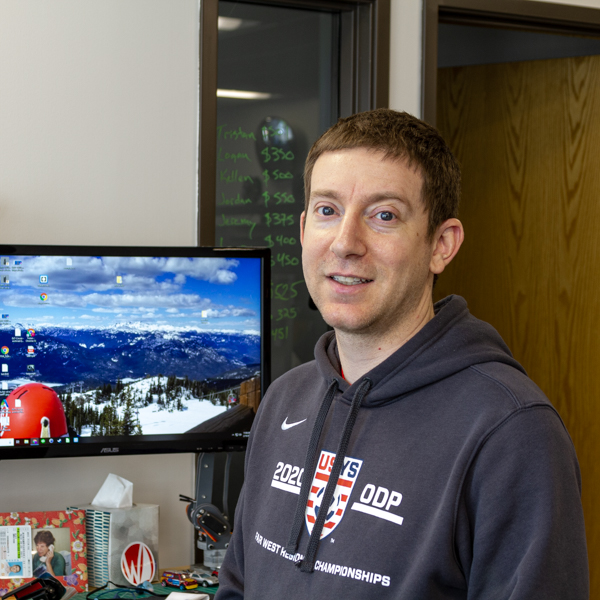 a portrait of Tristan in the office at his desk