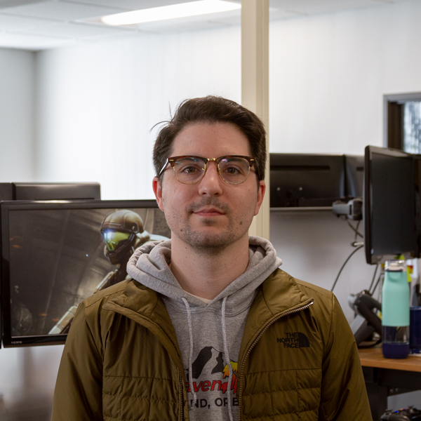 a portrait of Zack in the office at his desk